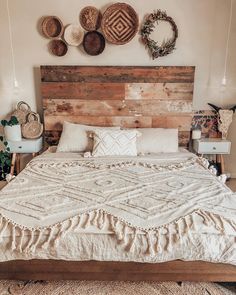 a large bed sitting in a bedroom next to baskets on the wall