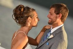 the bride and groom are smiling at each other