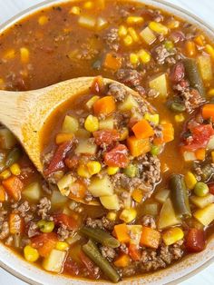 a bowl filled with soup and a wooden spoon