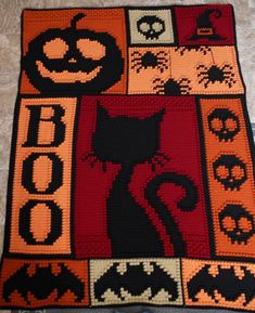 a crocheted halloween rug with a black cat on it