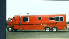 an orange truck parked in a parking lot