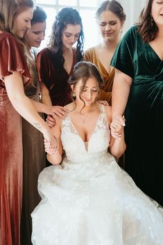 the bride is getting ready to walk down the aisle with her bridal party behind her