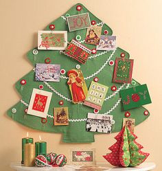 a decorated christmas tree with pictures and cards on it