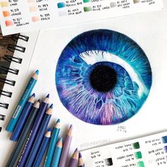 an eyeball drawing with colored pencils and watercolor pens on top of it