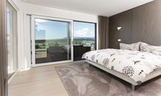 a bedroom with a large bed and sliding glass doors