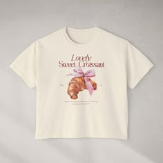 "Lovely Sweet Croissant" Women's Boxy Tee Oversized T-Shirt. Product Details: Available in S, M, L, XL, 2XL Colors: Ivory, Peachy, Butter, Pepper, Chalky Mint, and Orchid Boxy fit with heavy fabric (6.1 oz/yd2; (206.8 g/m2)) 100% ring-spun US cotton Made with ethically and sustainably sourced cotton OEKO TEX-certified dyes For best results, measure your favorite shirt and compare to our size chart. If you have any questions, we'll be glad to help! Care Instructions: Machine wash: cold (max 30C or 90F); Non-chlorine: bleach as needed; Tumble dry: low heat; Iron, steam or dry: low heat - Avoiding ironing directly on the design; Do not dryclean. Paris T Shirt, Boxy Tee, Oversized T Shirt, Dream Clothes, Favorite Shirts, Oversized Tshirt, Womens Clothing Tops, Clothing Brand, Gift For Her