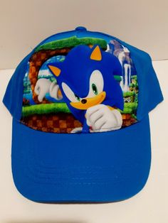 a blue sonic the hedge baseball cap on a white table