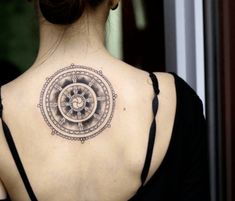 a woman with a tattoo on her back