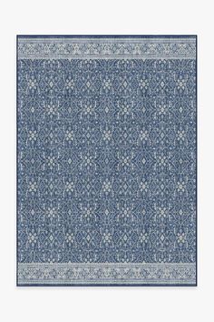 a blue and white rug with an intricate design on the bottom, in front of a white background