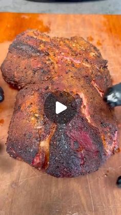 a large piece of meat sitting on top of a wooden cutting board