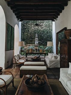 a living room filled with lots of furniture and a fountain in the middle of it