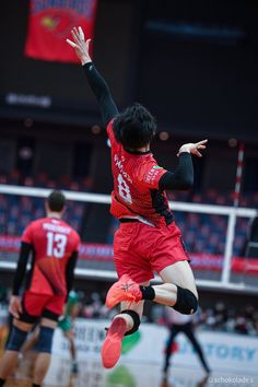 a man jumping up in the air to catch a frisbee on a court