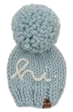 a blue knitted hat with the word love on it