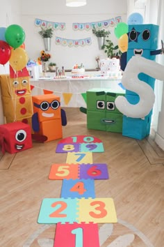 a birthday party with toys and decorations on the floor