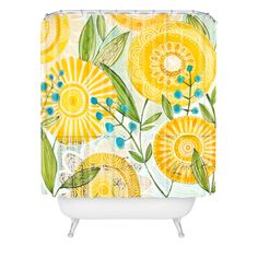 a shower curtain with yellow flowers and leaves on the outside, against a white background