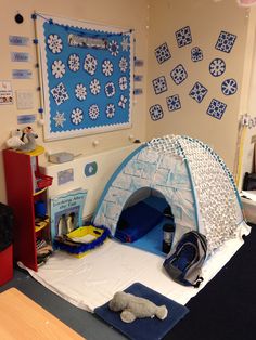 a room with a blue and white tent on the floor