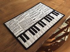 a close up of a piano keyboard on a wooden table with an ironing board