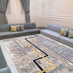 a living room with couches and a rug on the floor