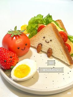 a plate that has some food on it with an egg, tomato and bread in the shape of a face