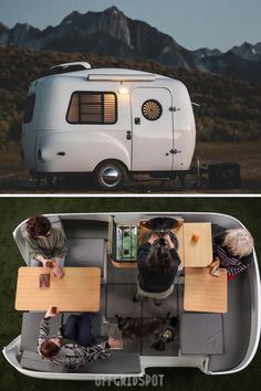 two people sitting at a table in front of a camper and an image of mountains