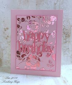 a pink birthday card with flowers on it