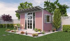 a small pink house sitting on top of a lush green field