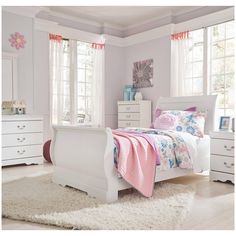 a bedroom with white furniture and pink decor on the walls, carpeted flooring