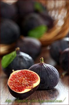 some figs are sitting on a wooden table