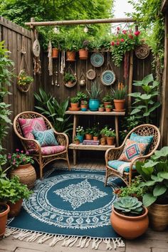 an outdoor patio with potted plants, chairs and rugs on the floor in front of a wooden fence