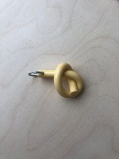 a pair of scissors sitting on top of a piece of wood next to a knot