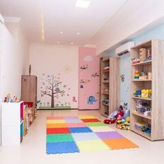 a child's playroom with colorful rugs and toys on the floor in it