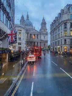 a rainy day in london with traffic and people walking down the street on a rainy day