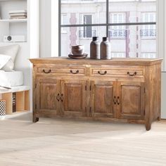 a large wooden cabinet sitting in front of a window