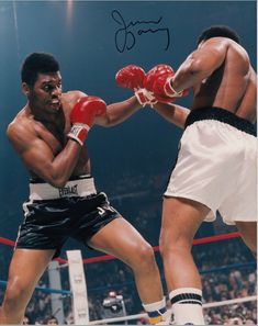 an autographed photograph of two professional boxers in the middle of a boxing match