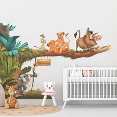 a baby's room with an animal mural on the wall and a crib