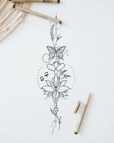 a drawing of a flower with two pens next to it