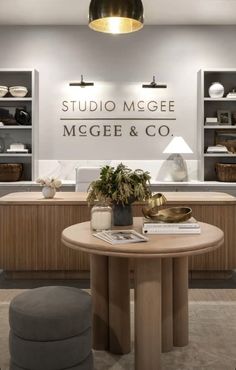 the interior of a store with furniture and accessories on display in front of a sign that reads studio mgee, megee & co