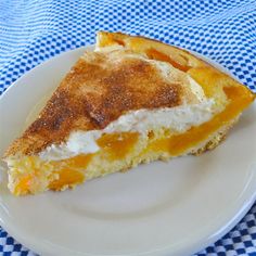 a slice of pie on a plate with blue and white checkered table cloth behind it