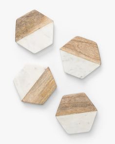 three wooden hexagonals with white marble and wood in the middle on a white background