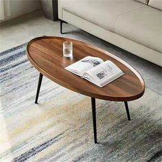 a coffee table sitting on top of a rug next to a couch