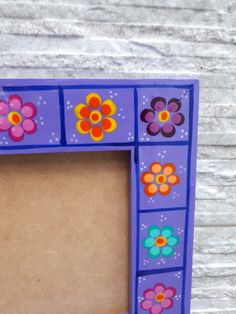 a purple frame with flowers painted on it