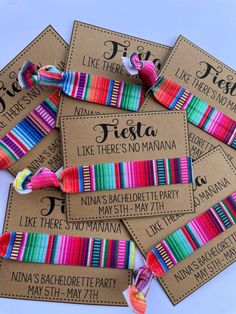 colorful ribbons are tied together on brown paper tags with names and colors that say fiesta