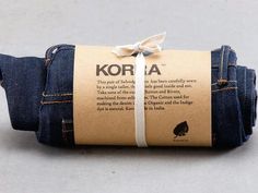 a pair of blue jeans tied up to each other with a label on the side