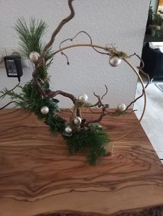 a wooden table topped with ornaments and greenery