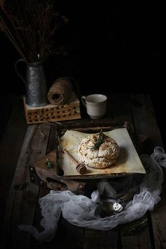 a table topped with a plate filled with food next to a cup and saucer