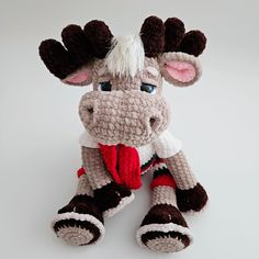 a crocheted stuffed animal wearing a scarf