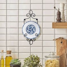 a blue and white plate sitting on top of a counter next to other kitchen items