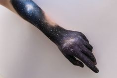 a person's arm with black and white stars painted on it