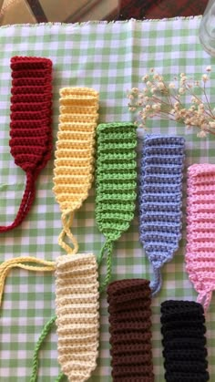 four crocheted items are lined up on a table