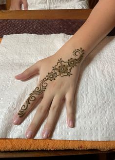 a woman's hand with henna on it